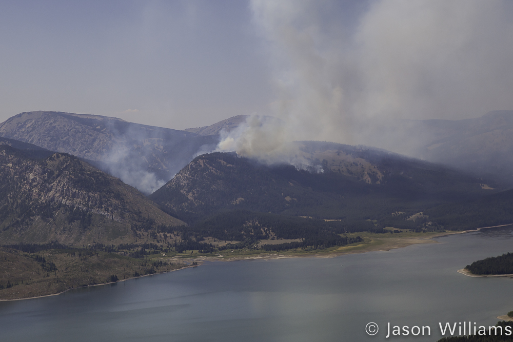 A Plume Of Smoke From The Berry Forest Fire In Grand Teton National Park Can Be Seen Rising Above The Lake