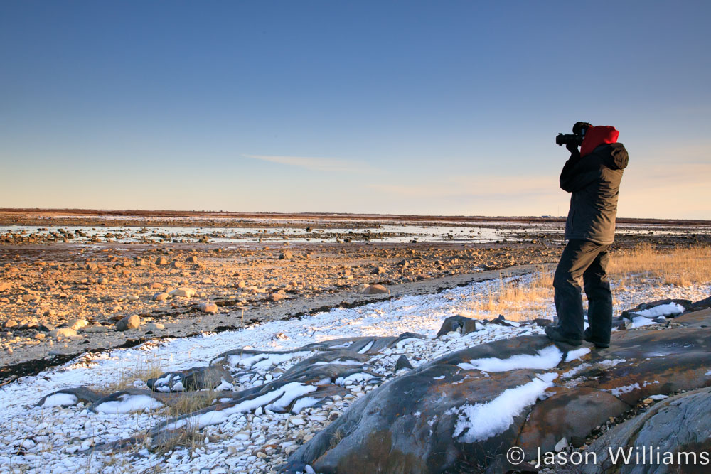 Photographer shooting the scenery of the coastline of Hudson Bay at low tide. 