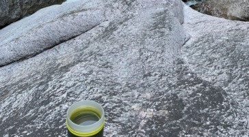 opened water bottle on rock