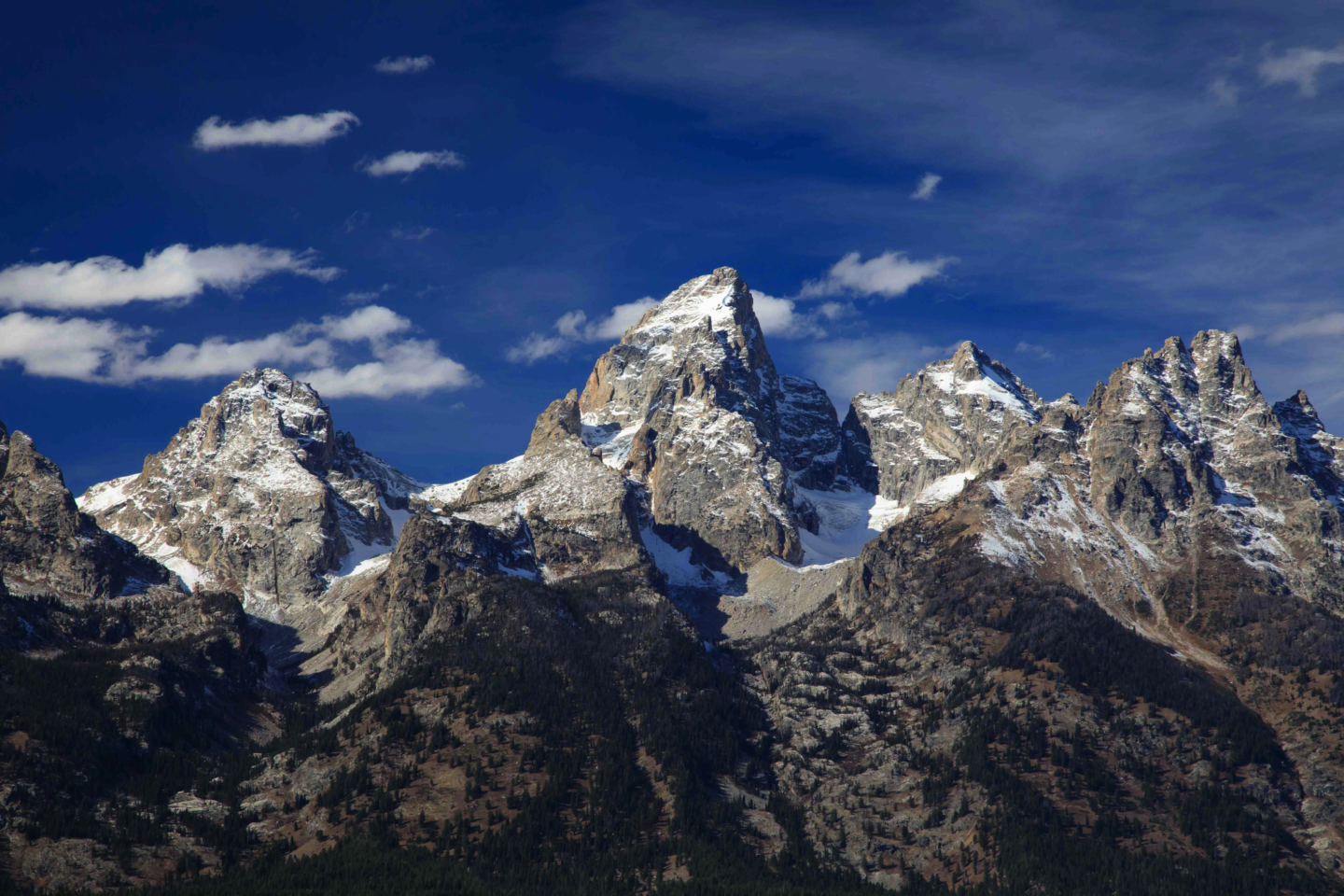 A Dramatic Image Of The Grand Tetons On A Sunny, Blue Sky Day