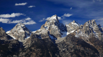 A Dramatic Image Of The Grand Tetons On A Sunny, Blue Sky Day