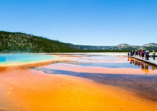 tourists visiting the Grand Prismatic Spring in Yellowstone National Park