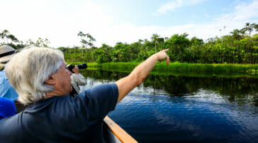 tourists on canoe exploring the amazon