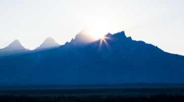 A Mountain View Of The Grand Tetons At Sunset