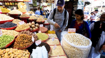 tourists buying food at market