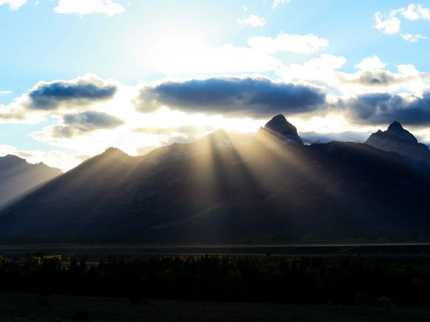 Sun Rays Break Over The Peaks Of The Teton Mountain Range In Grand Teton National Park