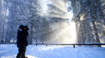 man photographing West Thumb Geyser Basin Yellowstone