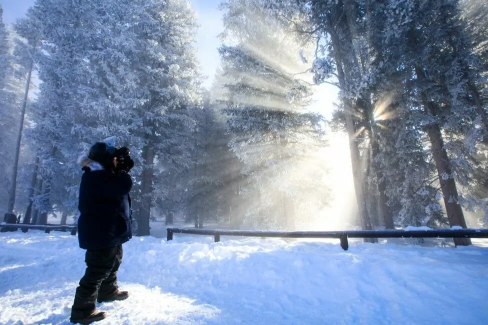 man photographing West Thumb Geyser Basin Yellowstone