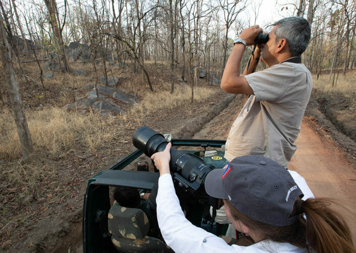 man and woman taking photos of wildlife