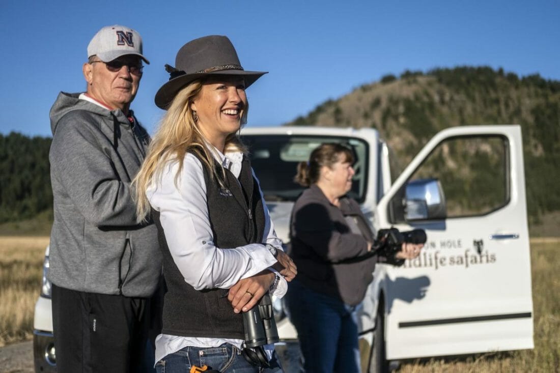 Professional Guide Ash Tallmadge Stands With Her Guests While On Safari With Jackson Hole Wildlife Safaris