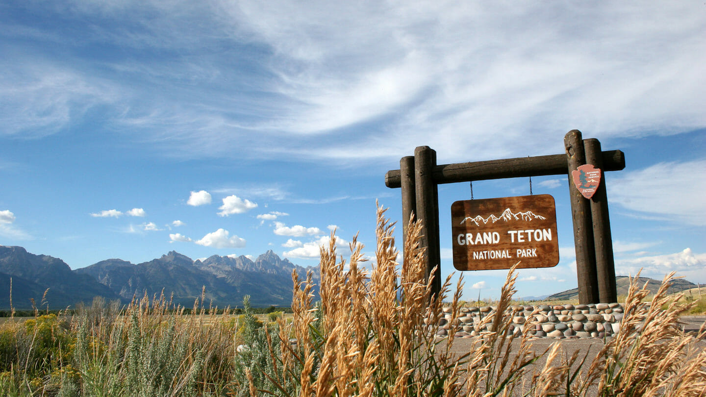 A Wooden Sign Marks The Southern Entrance To Grand Teton National Park