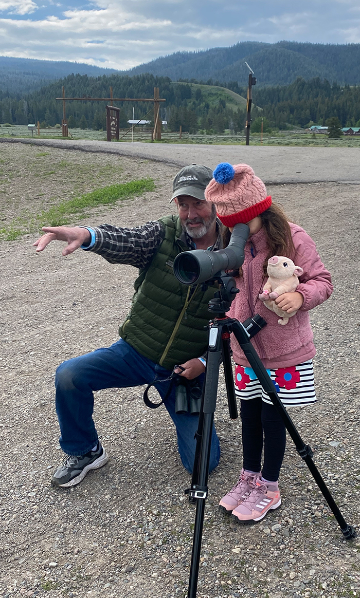 Professional Guide Jeffrey Meehan Instructs A Small Wildlife Enthusiast On What She Is Viewing In The Distance Through A Spotting Scope While On Safari In The Greater Yellowstone Ecosystem
