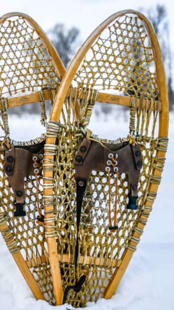 Two Vintage Snowshoes Sit In The Snow Ready For A Guided Eco Tour With Jackson Hole Wildlife Safaris