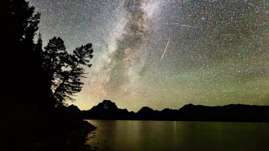 The Milky Way Is Highly Visible In The Night Sky Set Against The Backdrop Of The Teton Range With A Clear Silhouette Of Mount Moran In The Distance