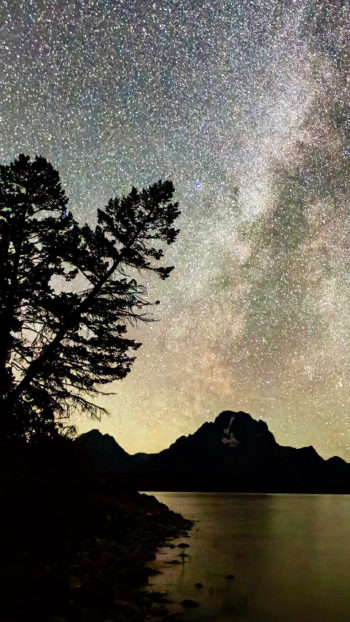 The Milky Way Is Highly Visible In The Night Sky Set Against The Backdrop Of The Teton Range With A Clear Silhouette Of Mount Moran In The Distance